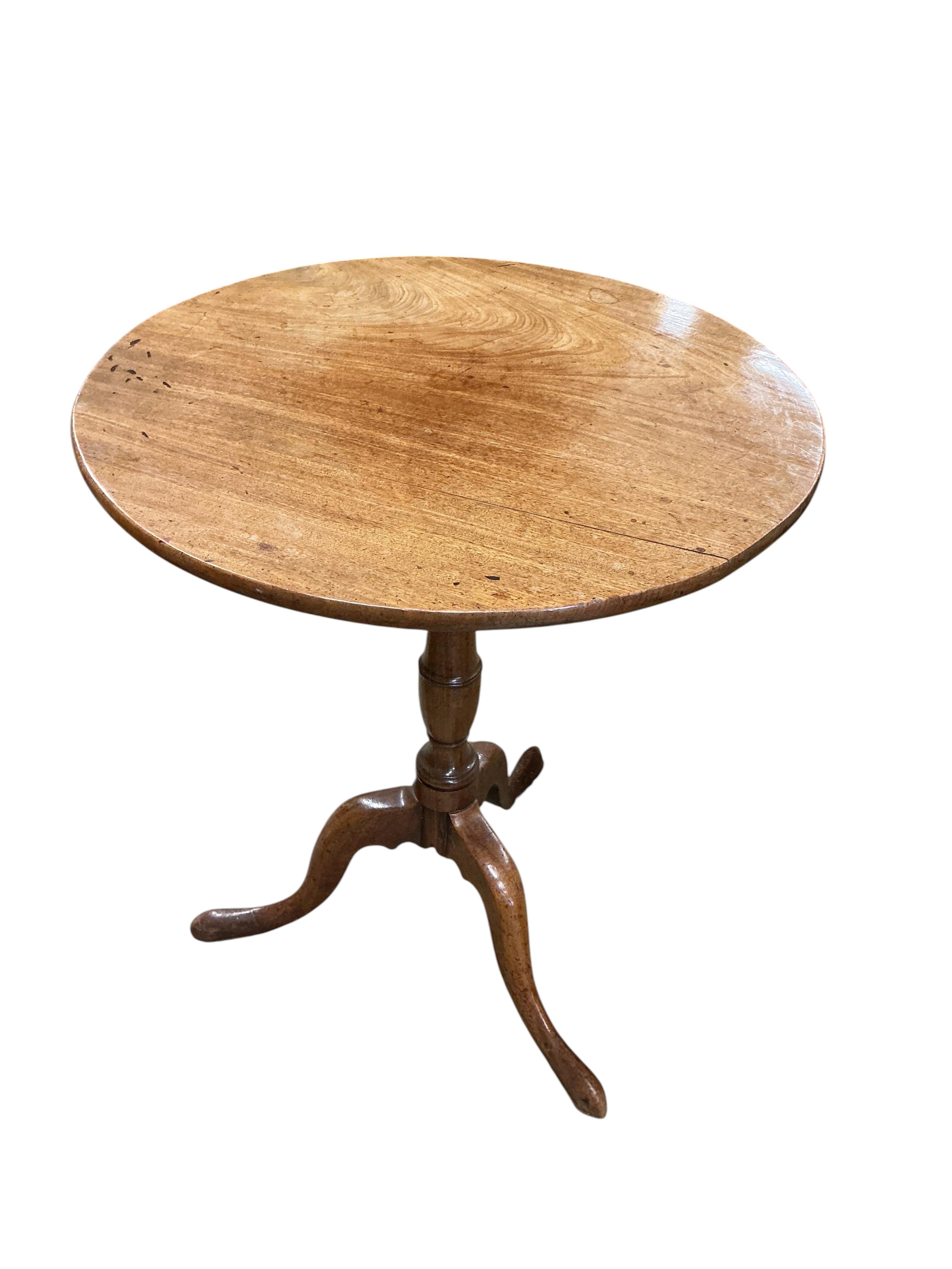 An early 19th century circular mahogany tilt top tripod tea table, diameter 59cm, height 71cm, together with an oak oval occasional table, adapted